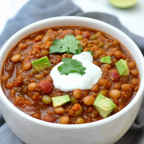 Lentil Chili Recipe served in a simple bowl, highlighting its rustic texture.