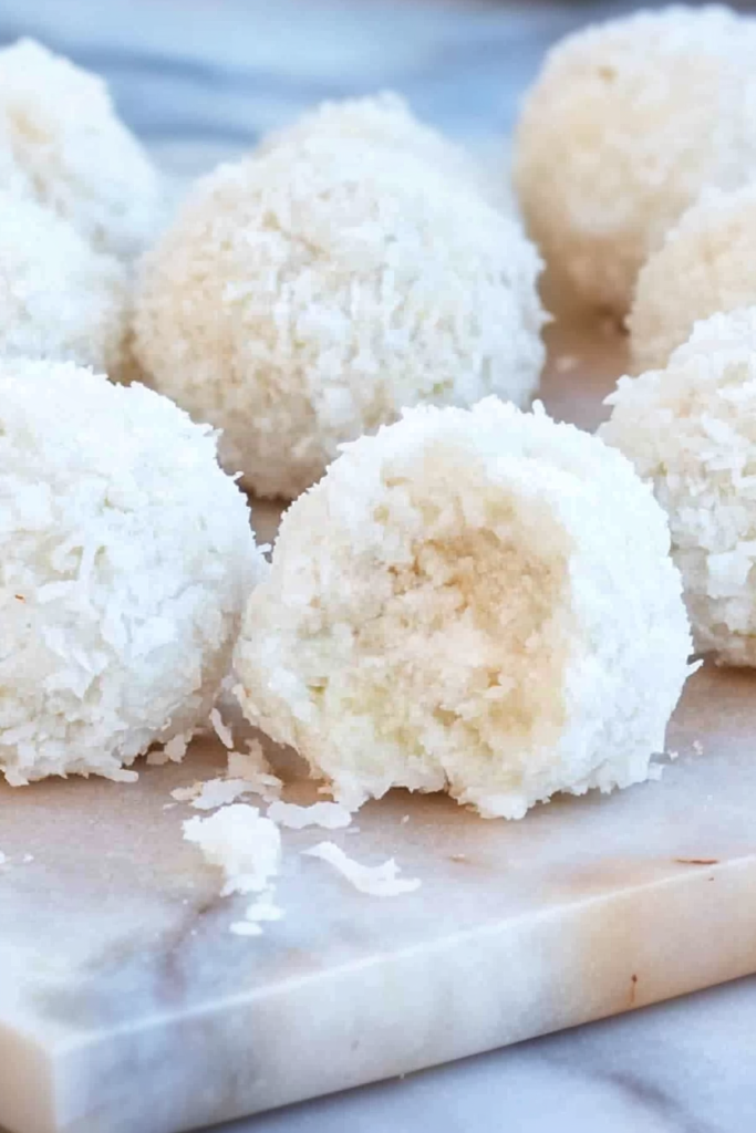 Bite-sized snowball sweets arranged neatly, showcasing the lime glaze sheen.