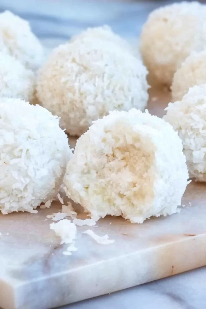 Bite-sized snowball sweets arranged neatly, showcasing the lime glaze sheen.