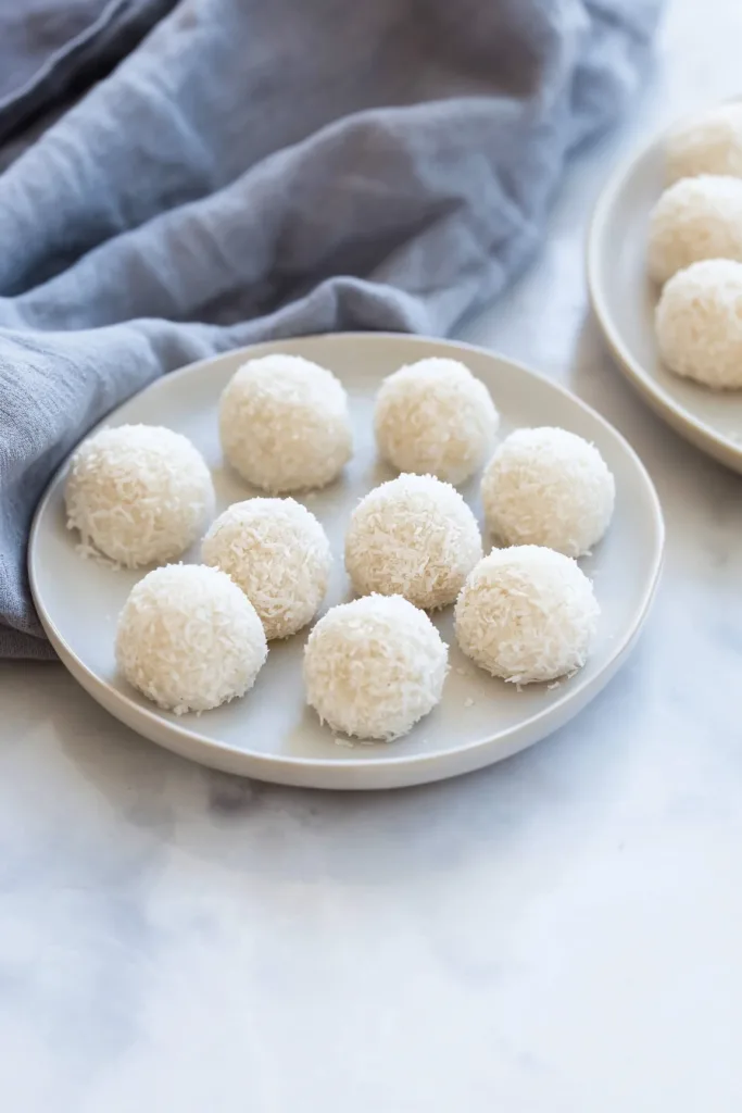 Cluster of coconut truffles with shredded coconut giving a snowy appearance.