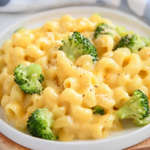 Golden, velvety cheese-covered pasta served with steamed broccoli
