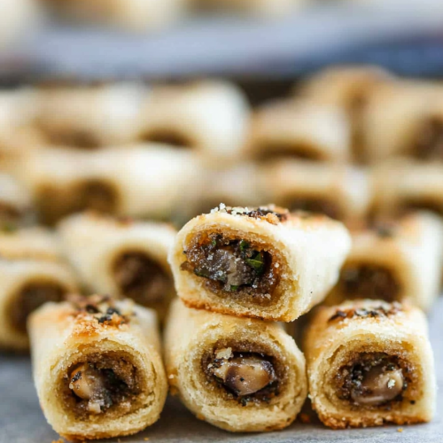 Homemade baked appetizer rolls with flaky pastry shells and flavorful mushroom stuffing
