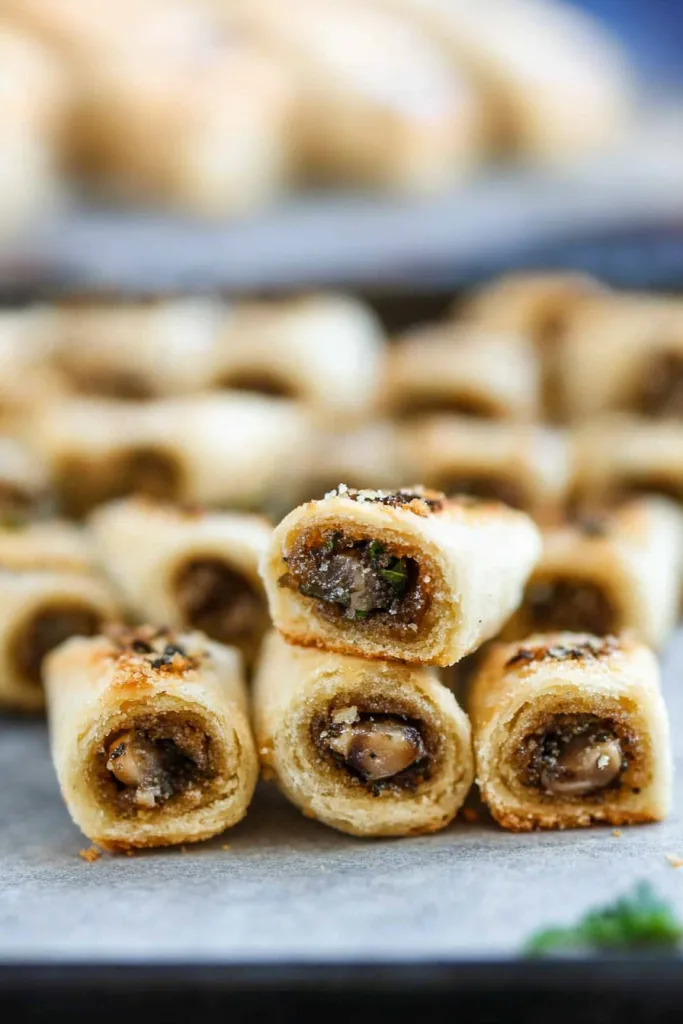 Homemade baked appetizer rolls with flaky pastry shells and flavorful mushroom stuffing