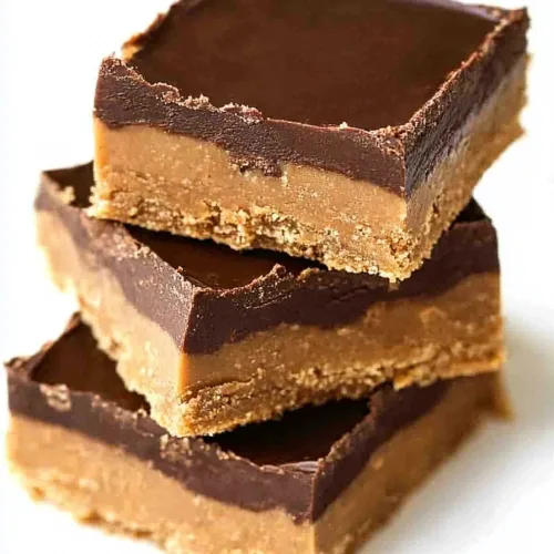Finished bars arranged on a plate, emphasizing the shiny chocolate surface and grainy texture beneath.