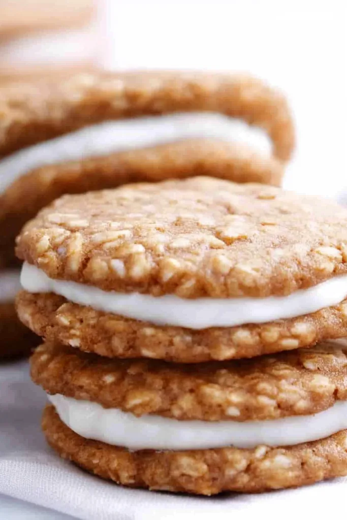 Rustic dessert display featuring oat-packed cookies paired with a creamy middle layer