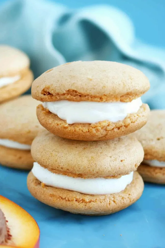 Dessert sandwiches arranged neatly, contrasting warm tones with a cool background.