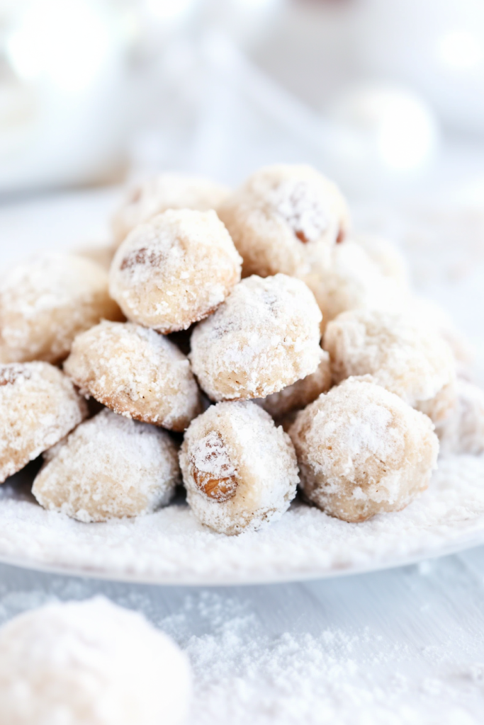 Round cookies coated in powdered sugar with a crumbly texture