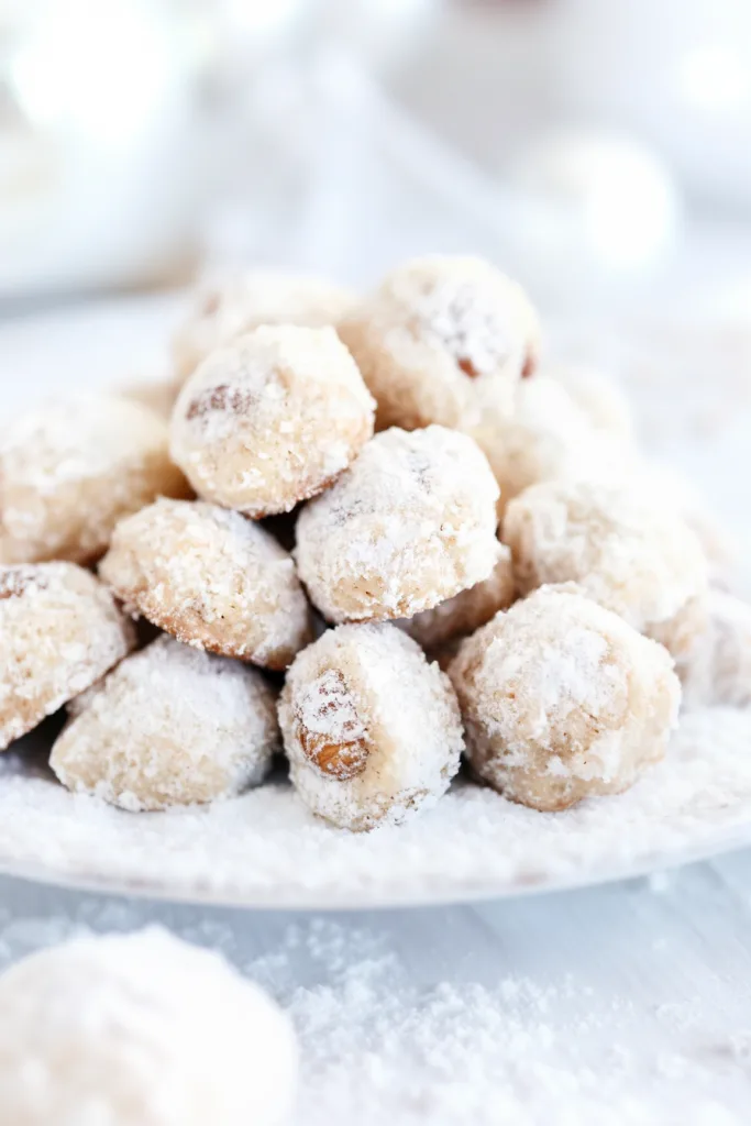 Round cookies coated in powdered sugar with a crumbly texture