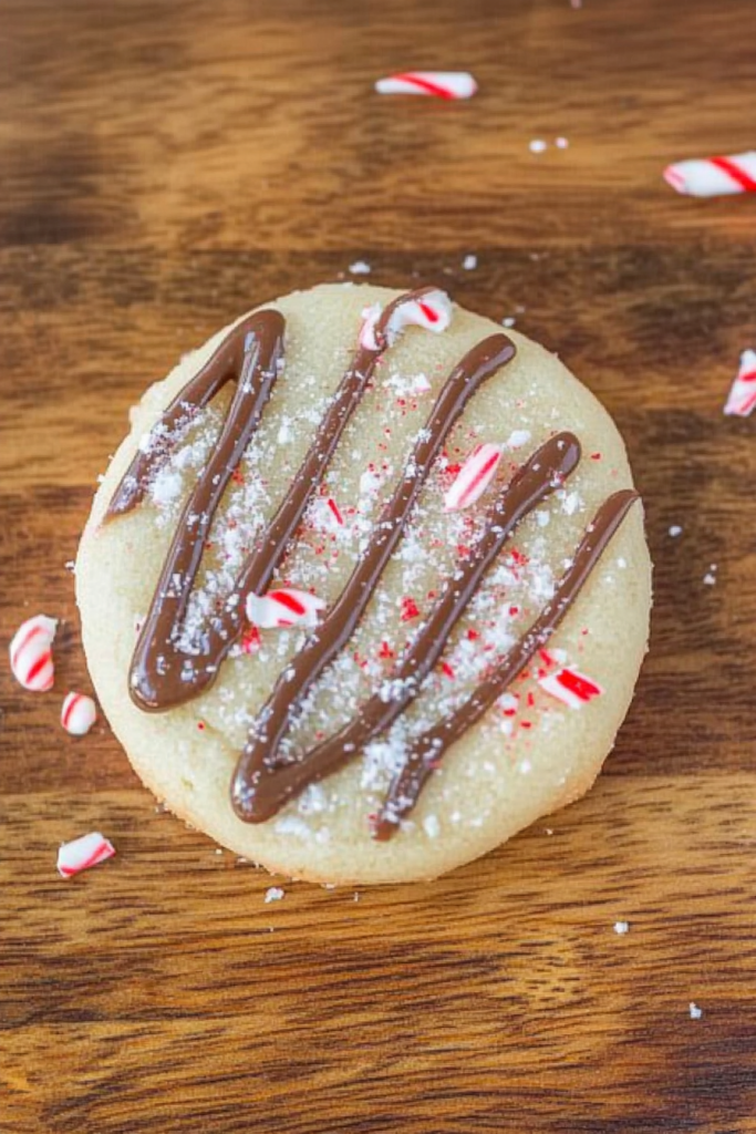 Golden sugar cookies topped with festive red and white candy pieces.