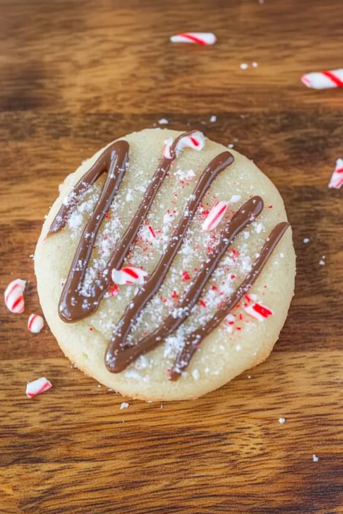 Golden sugar cookies topped with festive red and white candy pieces.