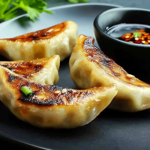 Rustic food scene highlighting dumplings with crisp edges and soft centers
