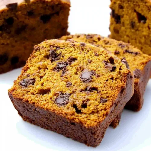 Sliced loaf showing moist orange-brown crumb with chocolate chips inside