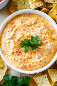 Crowd-pleasing game day snack featuring a creamy tomato cheese dip and chips
