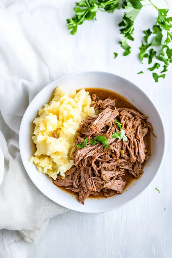 Tender shredded beef served with creamy mashed potatoes.