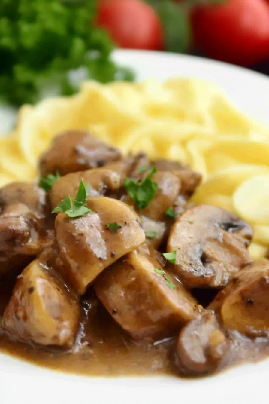 Close-up of seared beef tips with mushrooms in a creamy brown gravy