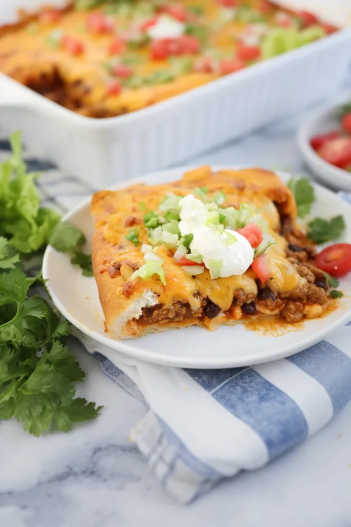 Golden crescent roll taco bake filled with seasoned beef and melted cheddar cheese.