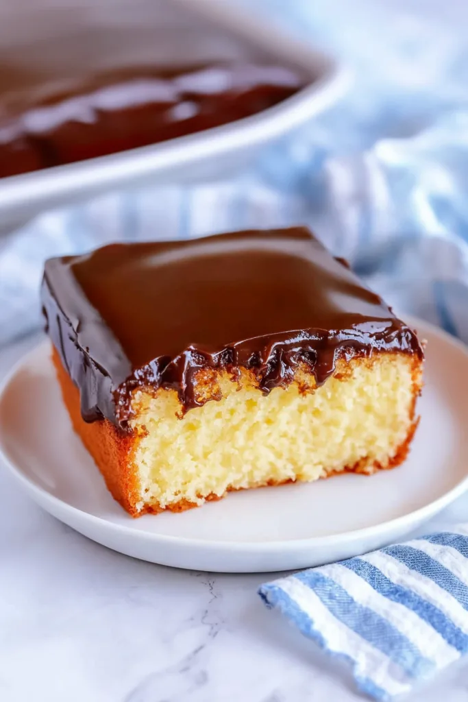 Close-up of moist cake with thick chocolate layer.