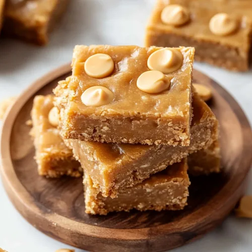 Plate of rich baked bars studded with butterscotch chips, styled simply.