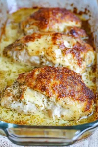 Close-up of seasoned chicken layered with bubbly provolone and herbs.