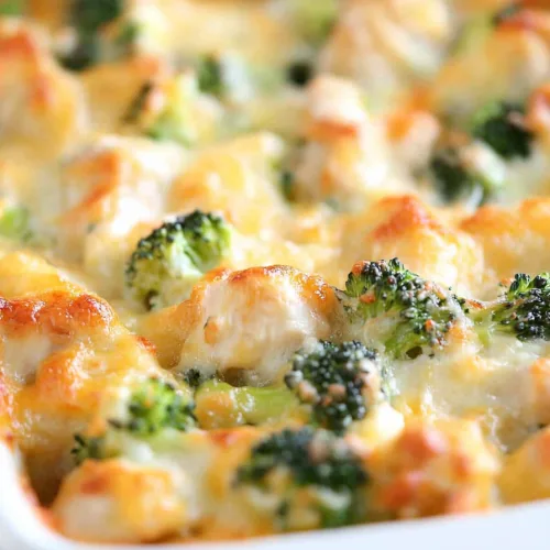 Freshly baked casserole highlighting the contrast of green broccoli and golden cheese.