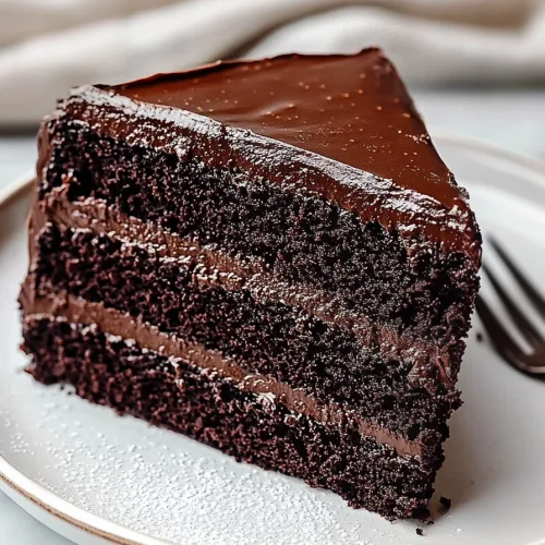 Chocolate Fudge Cake served with fork and sugar garnish.