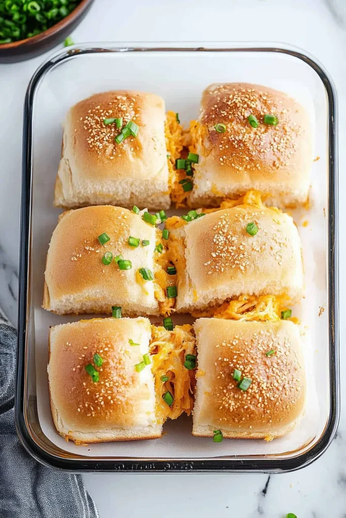 Warm sliders with sprinkled parsley and red pepper flakes for garnish.