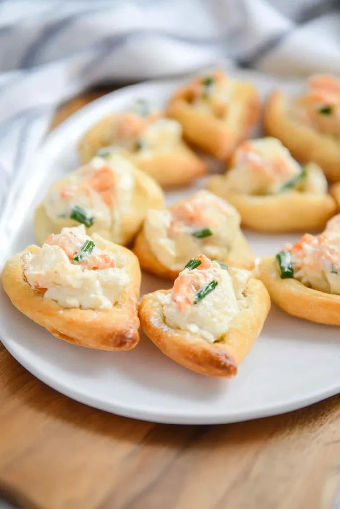Final shot of golden-brown appetizers with creamy filling and fresh herbs.