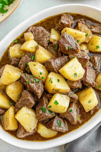 Stew-like dish highlighting juicy meat, golden potatoes, and glossy gravy.