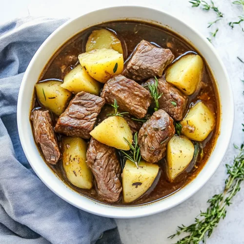 Tender beef chunks and soft potatoes coated in rich brown gravy.