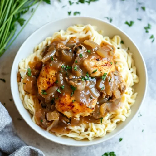 Savory chicken and gravy served over pasta for a hearty meal.