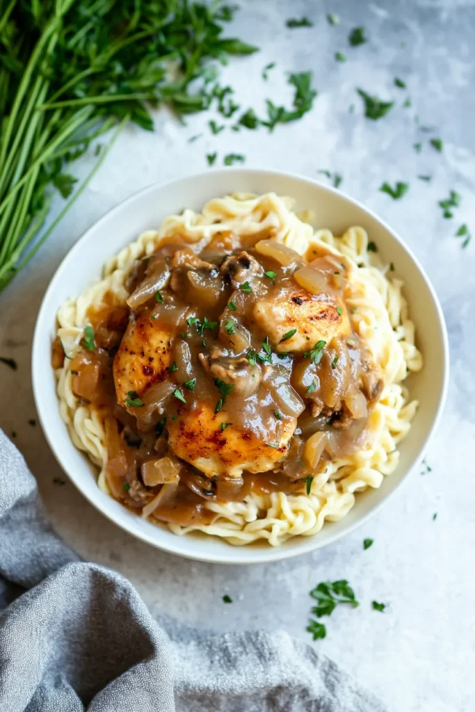 Savory chicken and gravy served over pasta for a hearty meal.