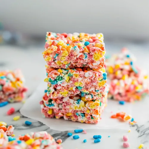 Stacked cereal bars showing bright rainbow colors and chewy texture.