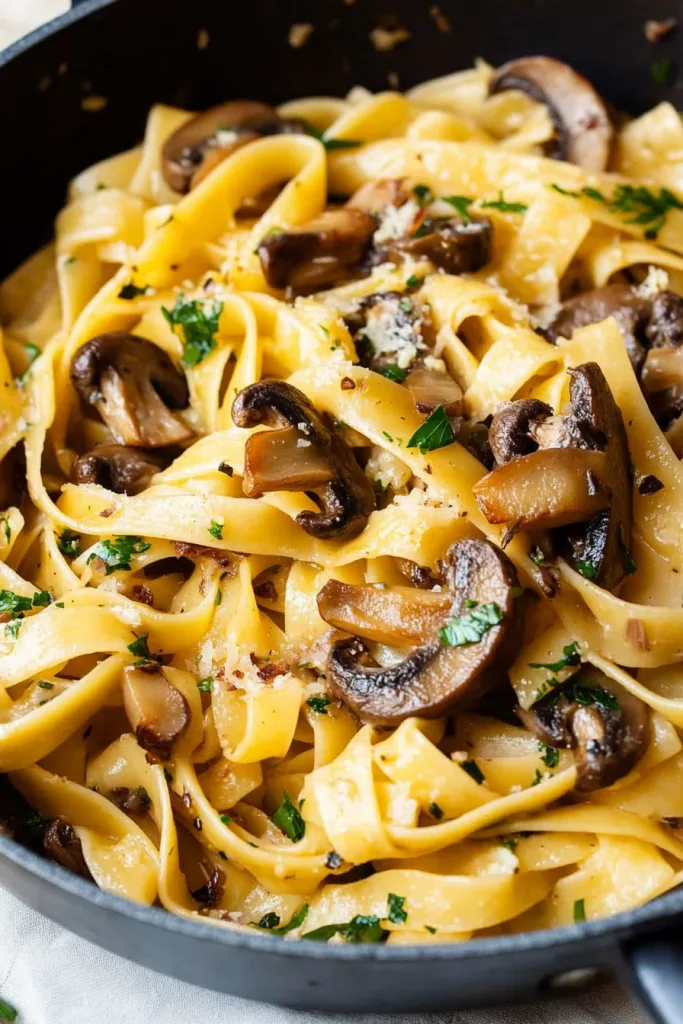 Golden noodles intertwined with earthy mushrooms, finished with a sprinkle of herbs.