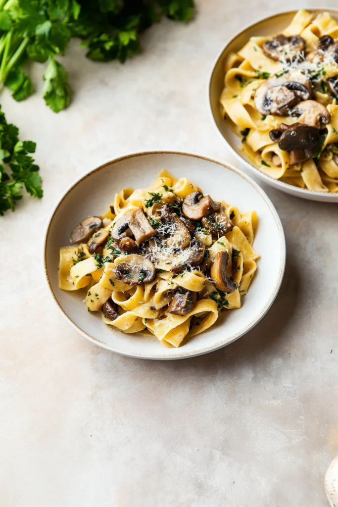 Rustic pasta dish highlighting tender mushrooms and a glossy sauce coating.