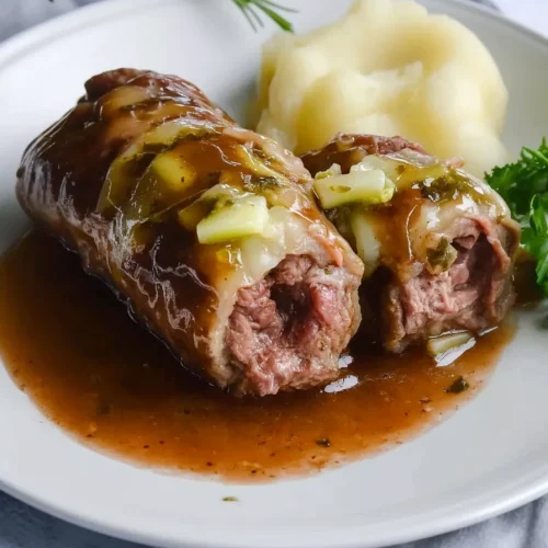 Rolled beef slices filled with onions and pickles, topped with rich gravy.