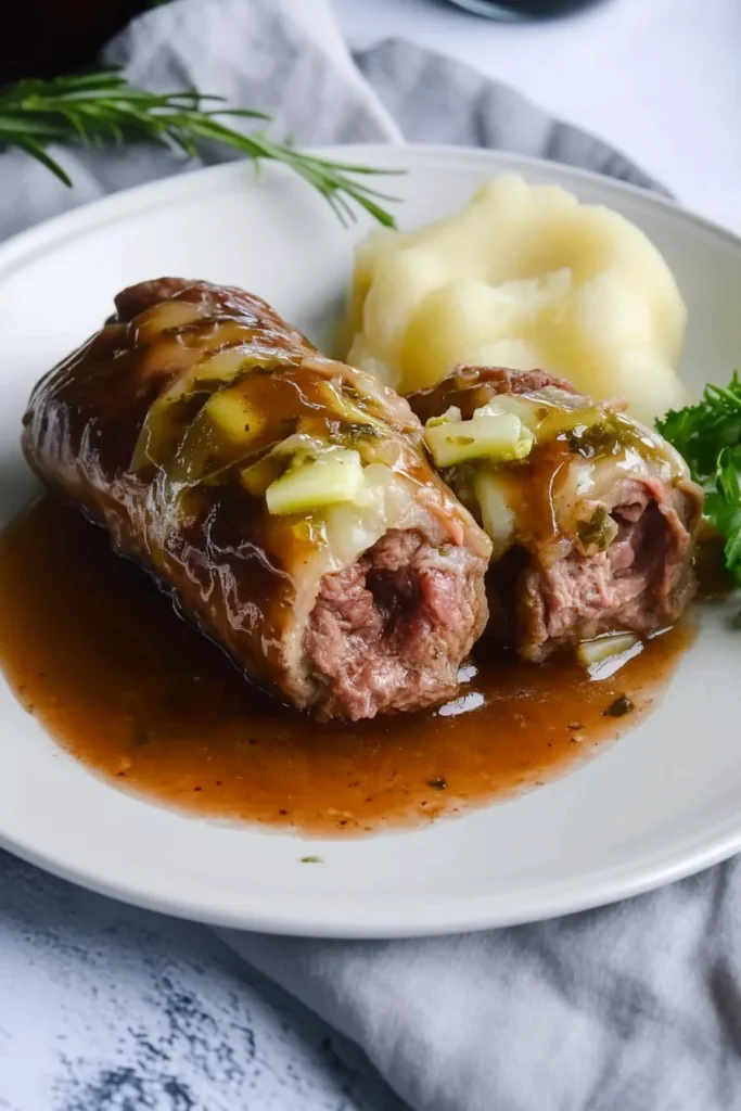 Rolled beef slices filled with onions and pickles, topped with rich gravy.