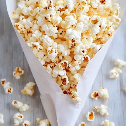 Snack presentation showing popped corn against a soft, neutral background.