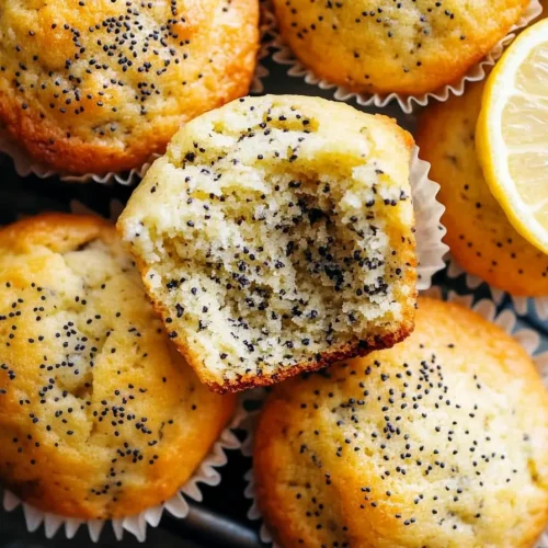 Batch of warm muffins highlighting poppy seed detail