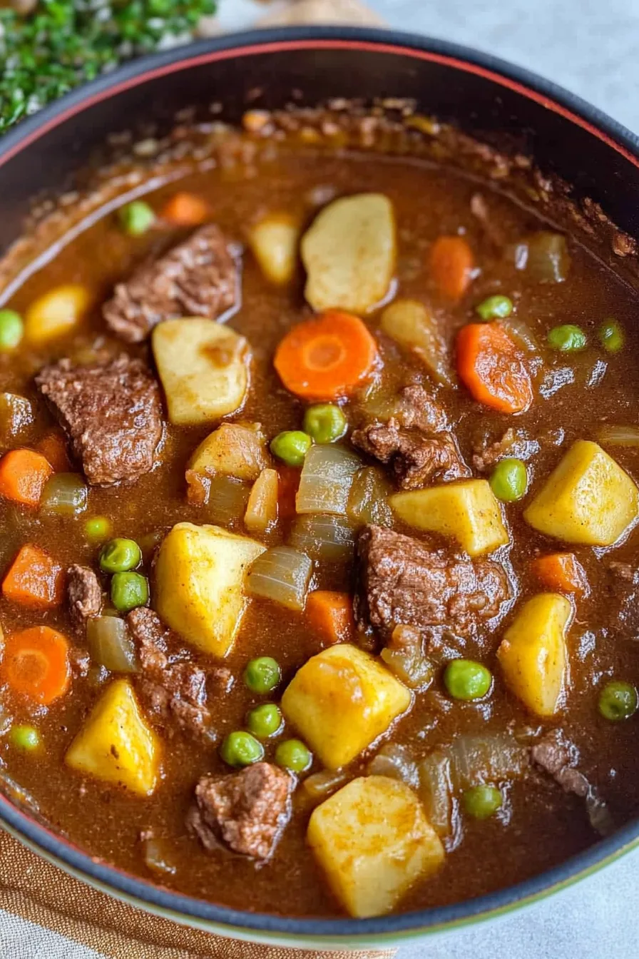 Warm, home-cooked stew highlighting colorful carrots and golden potatoes.