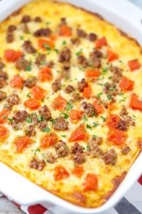 Golden-brown casserole topped with browned sausage and melted cheese.