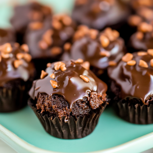 Rows of small frosted chocolate squares arranged neatly on a serving tray.