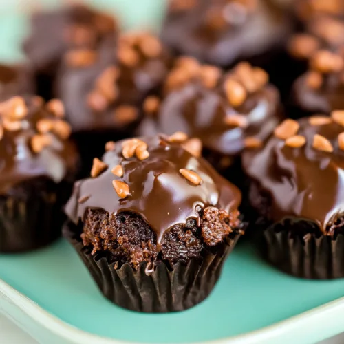 Rows of small frosted chocolate squares arranged neatly on a serving tray.