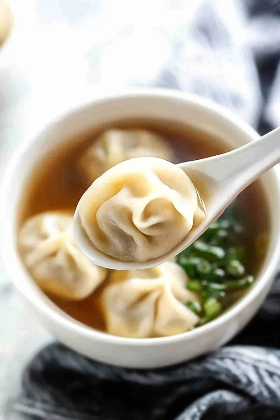 Classic comfort dish showing dumplings nestled in golden liquid.