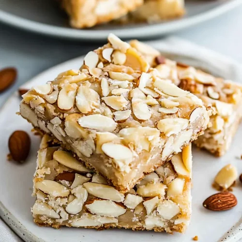 Two bars stacked neatly, showing caramelized almond topping.