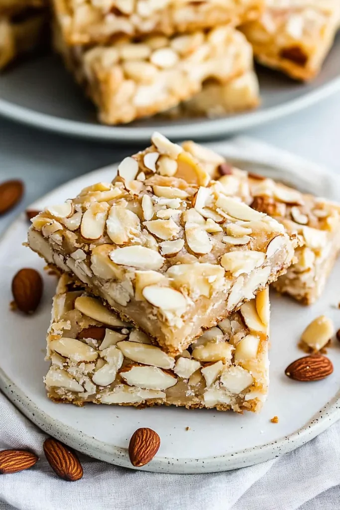Two bars stacked neatly, showing caramelized almond topping.