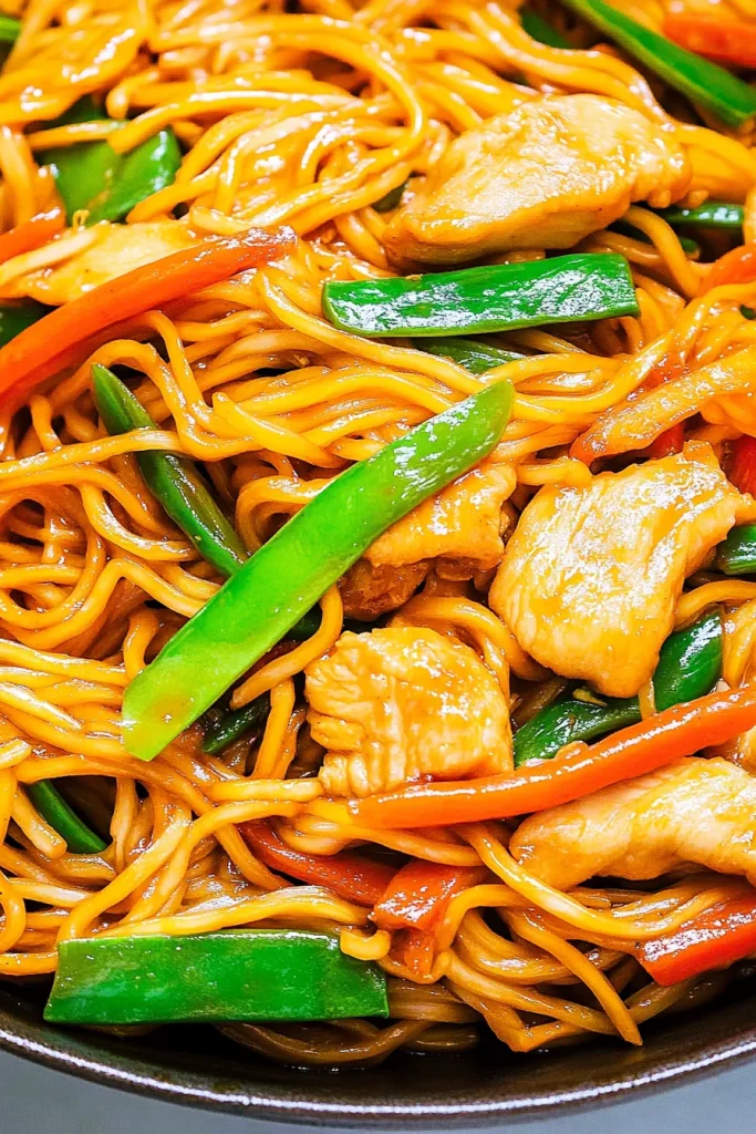Savory stirโfried noodles coated in sauce, served warm