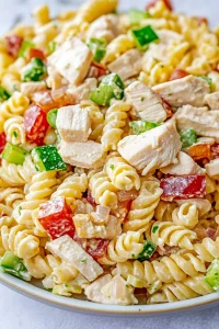 Hearty cold pasta dish featuring creamy-coated noodles and crisp red and green peppers.