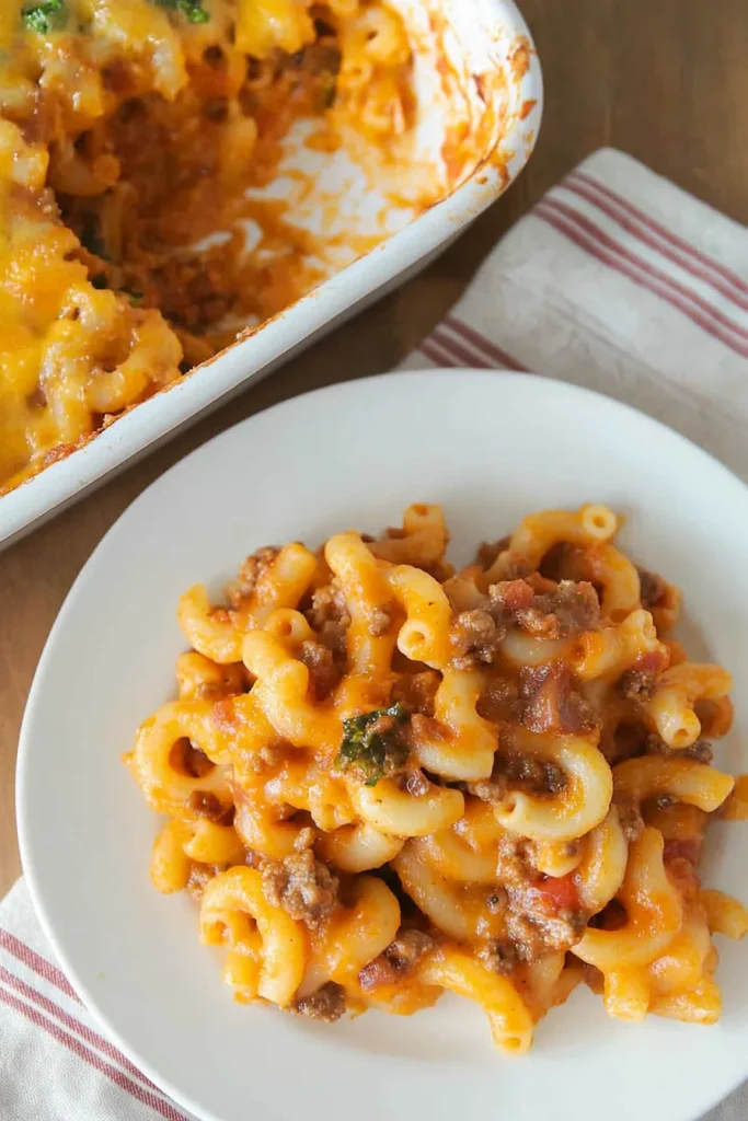 Hearty pasta casserole highlighting its cheesy crust and rich filling.