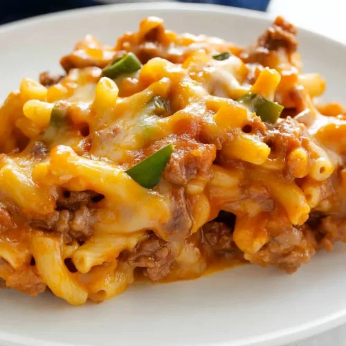 Baked macaroni with golden melted cheese and parsley garnish.