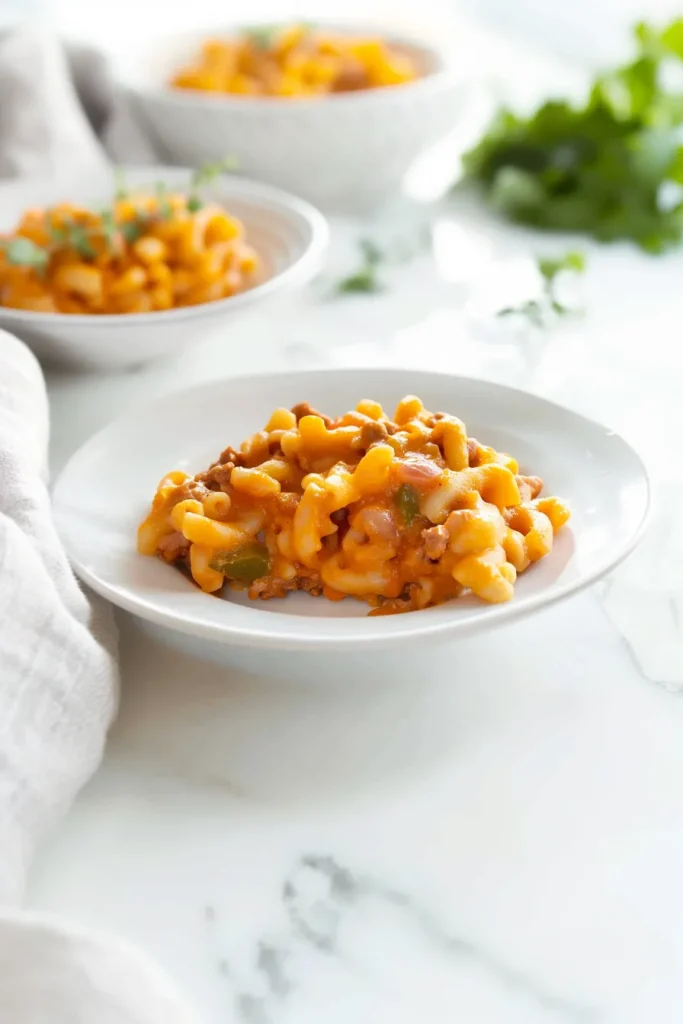 Classic Creole macaroni with savory meat sauce and melted cheese topping.